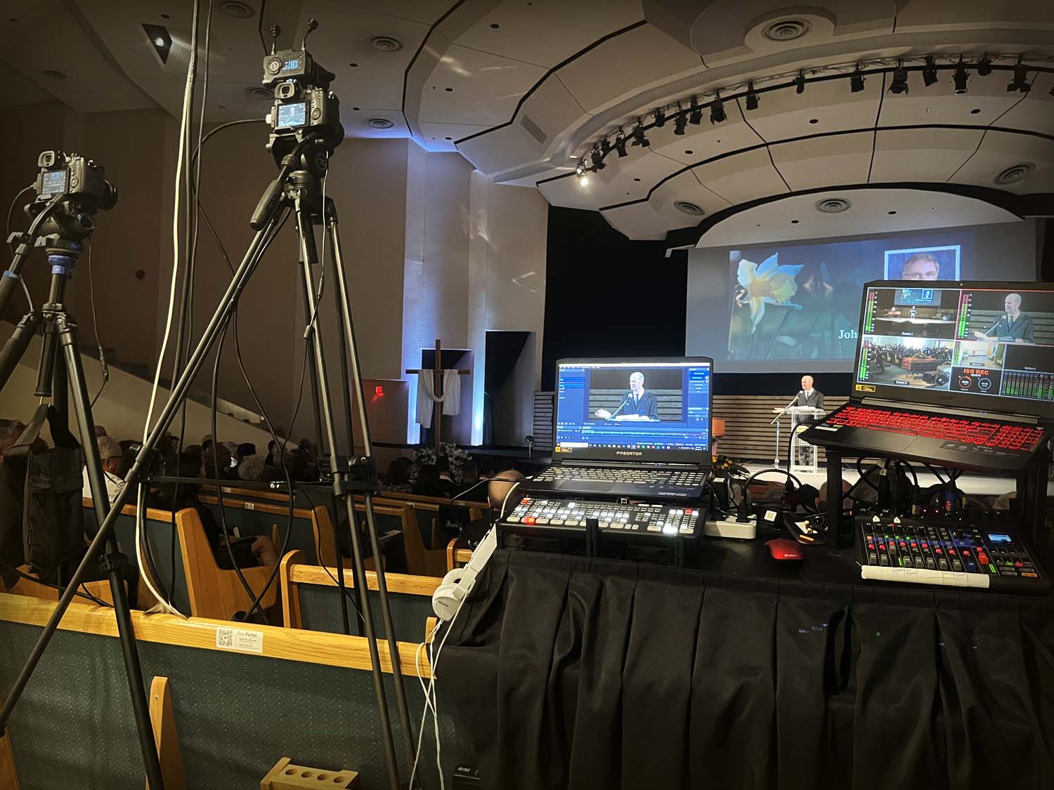 Live funeral video mixing station with audio board and laptop